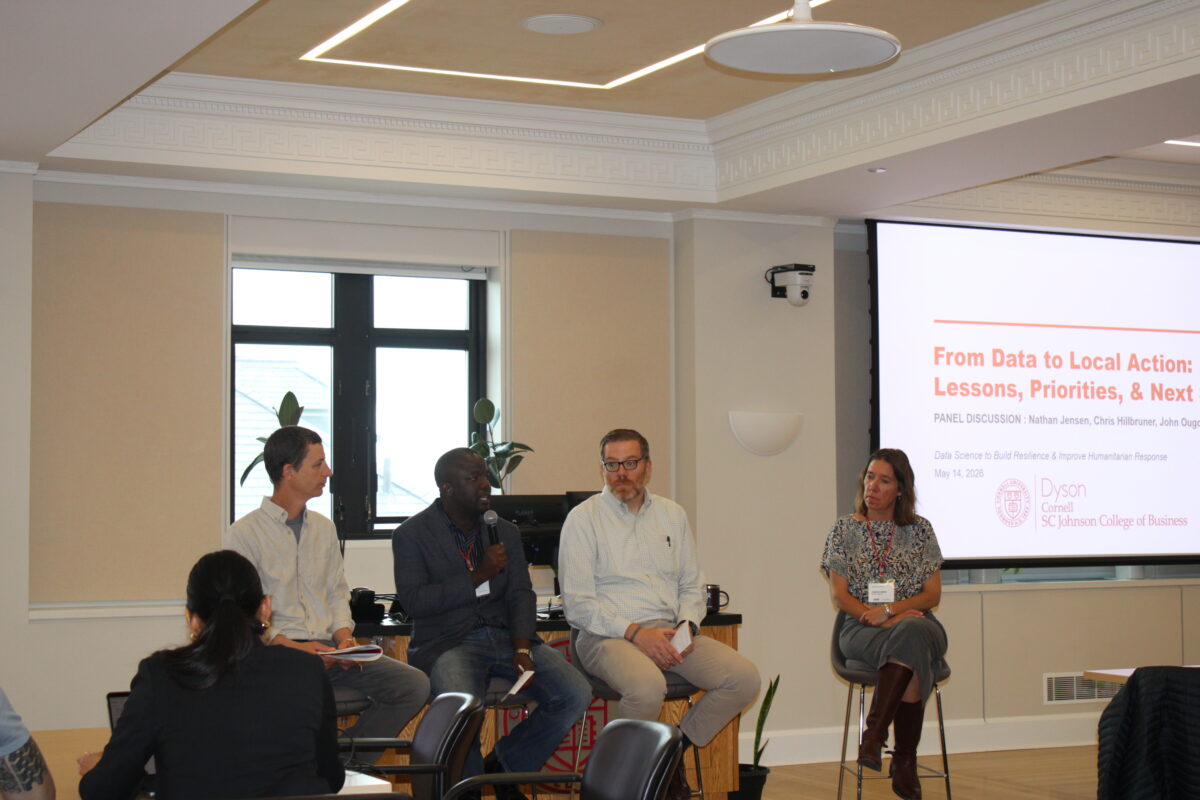 Panelists seated in front of a screen reading From Data to Local Action: Lessons, Priorities, and Next Steps